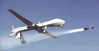 A Predator drone firing a Hellfire missile.